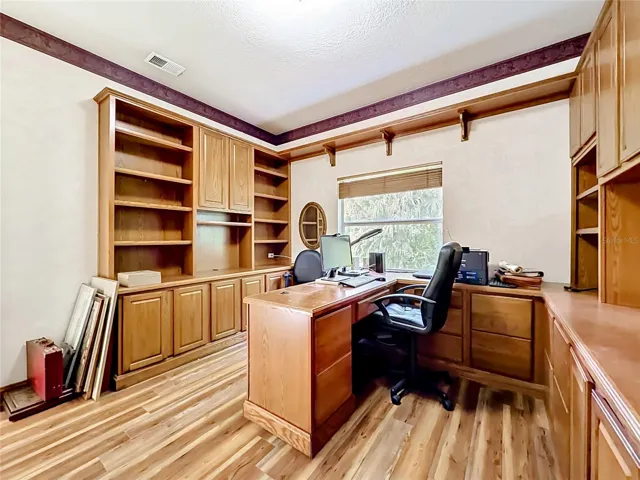 Dedicated home office with custom built-in shelving and workspace