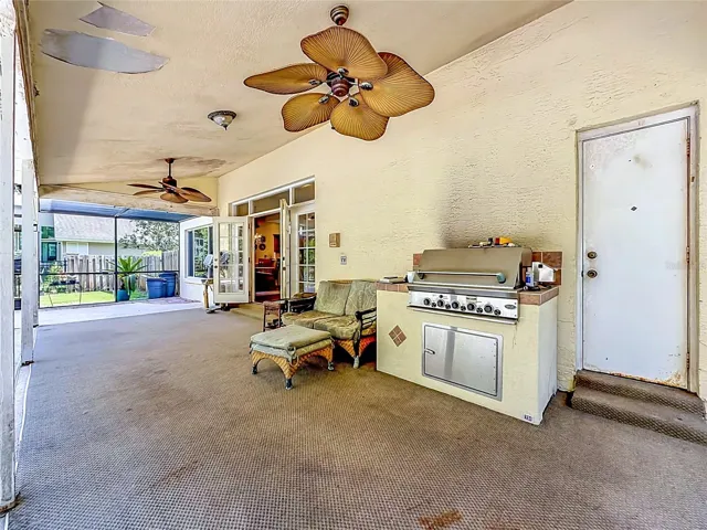 Expansive covered lanai overlooking the pool, perfect for outdoor dining and entertaining year-round