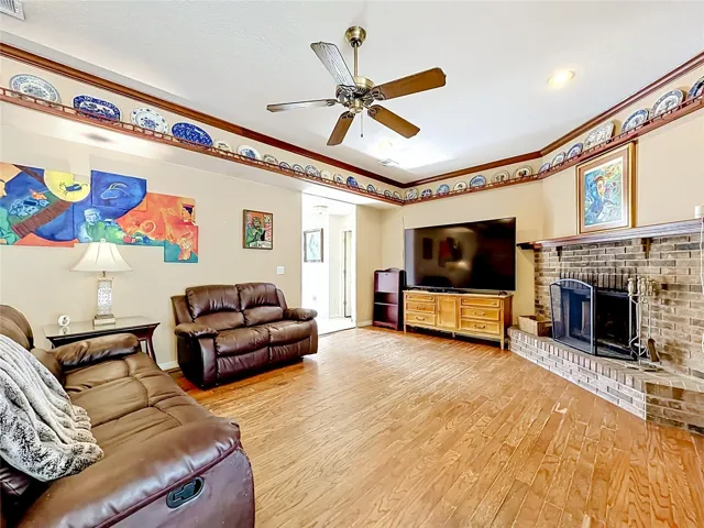 Spacious family room with wood-burning fireplace and expansive backyard views