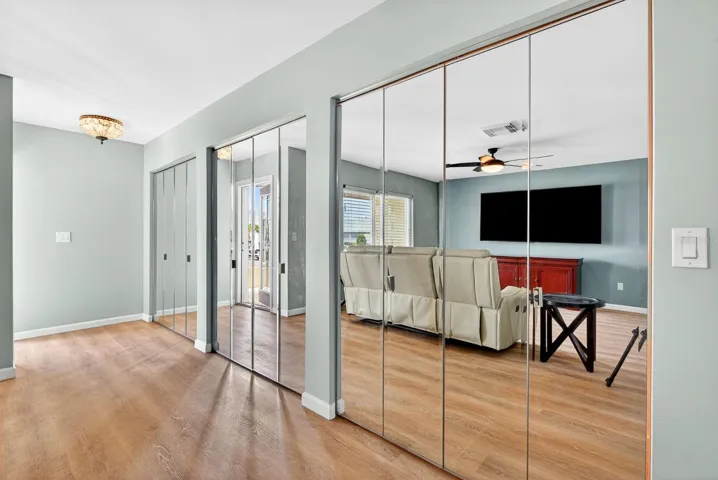 Looking at the front door with storage closet to the right.