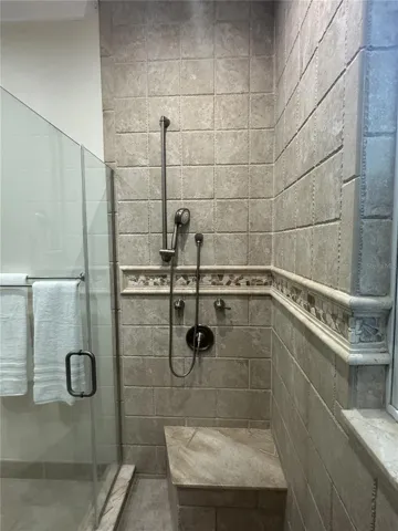 Left side of Dual Shower Heads with bench and Rain shower above