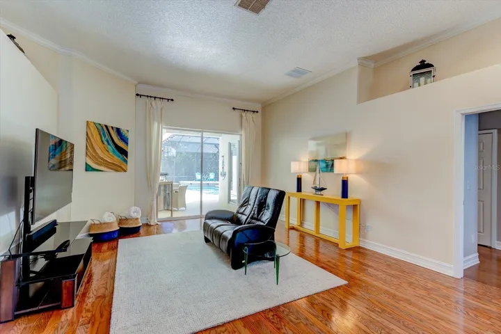 Living room with access through over-sized sliding glass doors to the outside paradise