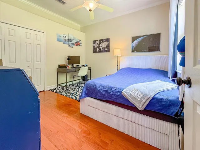 Another bedroom with wood flooring and gorgeous garden view