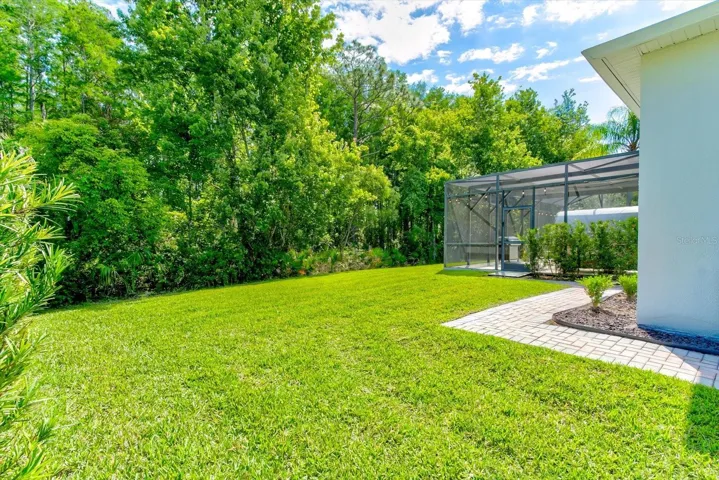 Backyard with walkway to the pool equipment
