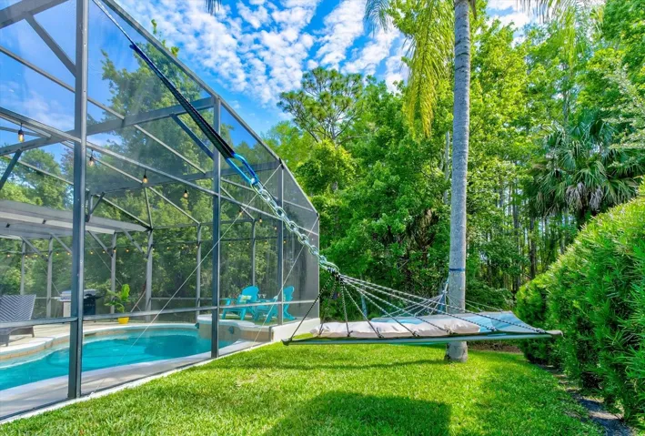 A hammock in between two palm trees - this home feels like a vacation