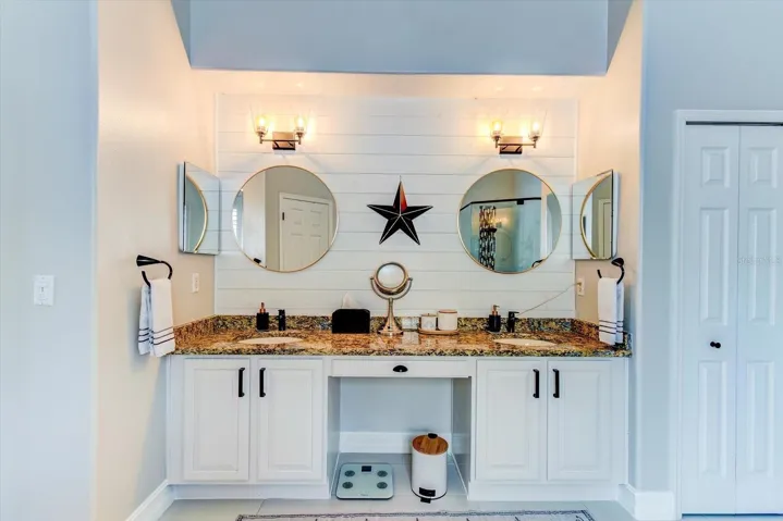 Primary bathroom with double sinks and shiplap wall
