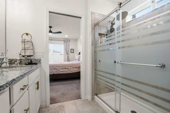 Primary walk in shower with updated glass doors