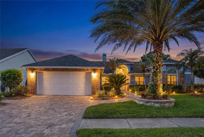 Beautiful landscape lighting highlights the home at night!