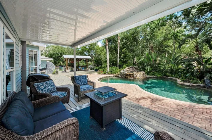 Covered outdoor sitting with fire pit and Blackstone Grill