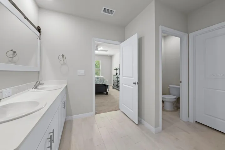 Primary bathroom cont. with private water closet and large walk-in closet.