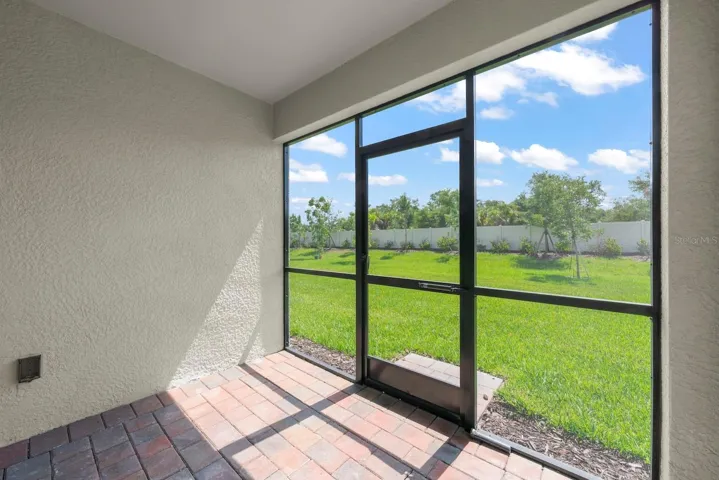 Screened in patio facing large yard.