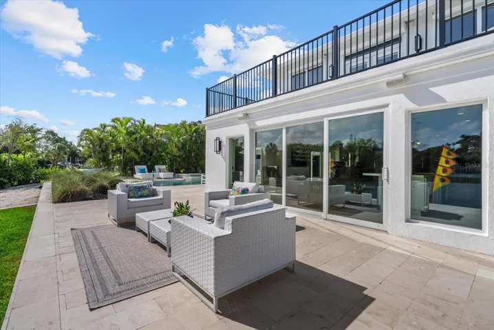 Large travertine patio just outside the kitchen slider; plenty of room for a dining table and chairs.