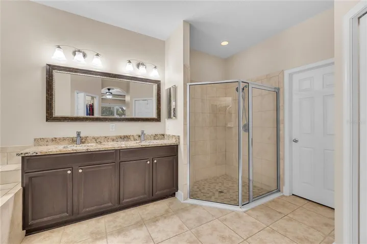 This glass walk-in shower has a handy built-in bench.