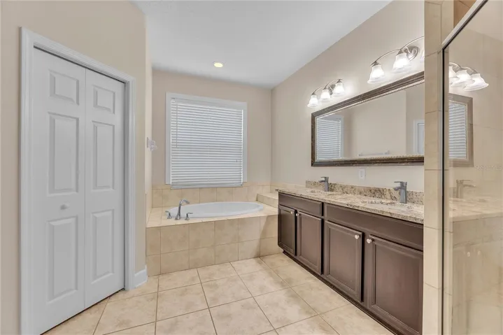The primary bathroom has dual sinks, a relaxing soaking tub, and separate shower and W/C.
