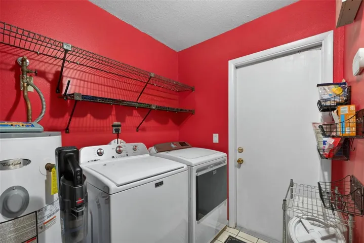 Laundry room with pantry and door leading to the pool area.