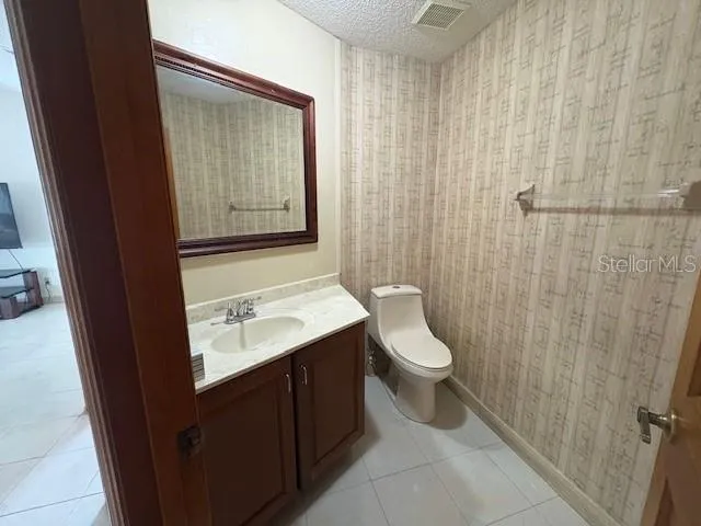 Half bath in the hallway close to the den/kitchen.