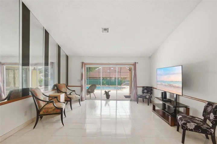 View as you enter the home of the formal living room looking out to the pool