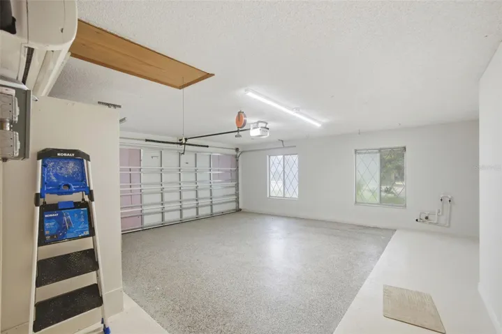 Resurfaced concrete floor, pull down stairs to the attic, plumbed for water softener and a split AC unit in the garage!