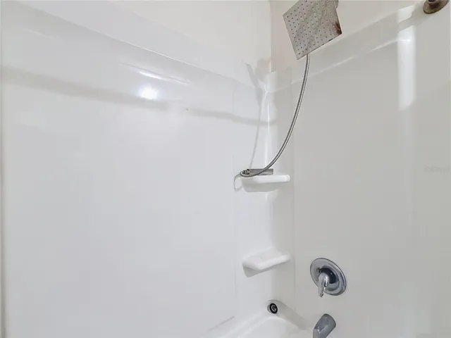 the second bathroom tub and shower combination