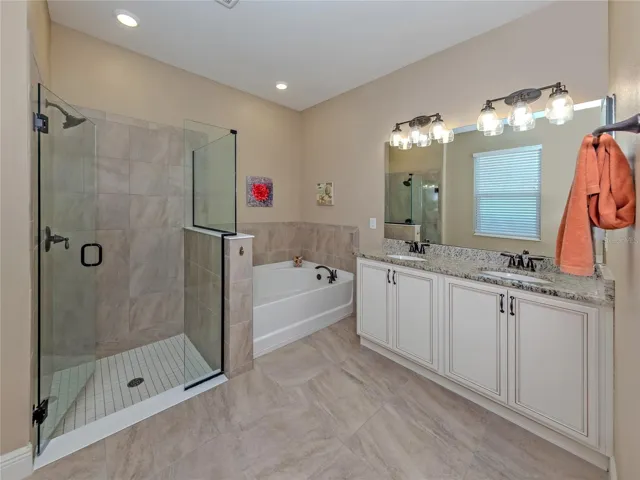 The large master ensuite features solid wood cabinetry, soft close drawers, garden tub, dual sinks, walk in glass shower and private water closet
