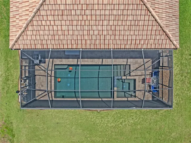 This pool home features plenty of green space too!