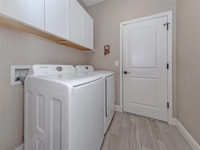 The laundry room includes additional storage.