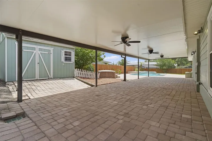 LARGE covered back porch with pavers!