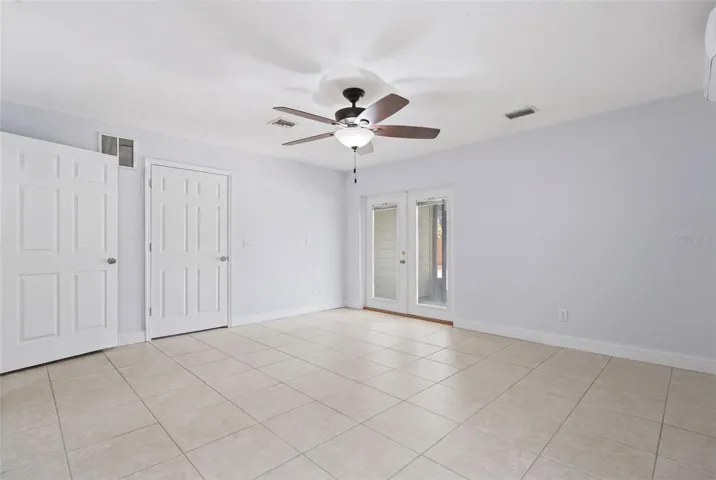 French Doors into private screened in patio overlooking the pool.
