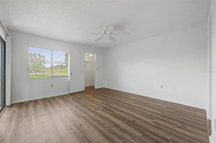 Primary Bedroom offers en-suite bathroom, 3 walk-in closets and sliders to the screened balcony.