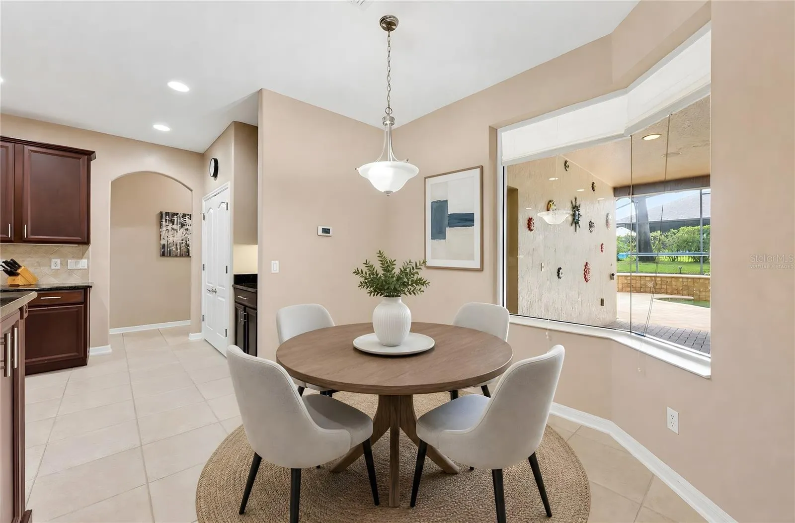 Breakfast nook overlooking the pool. Virtually Staged.