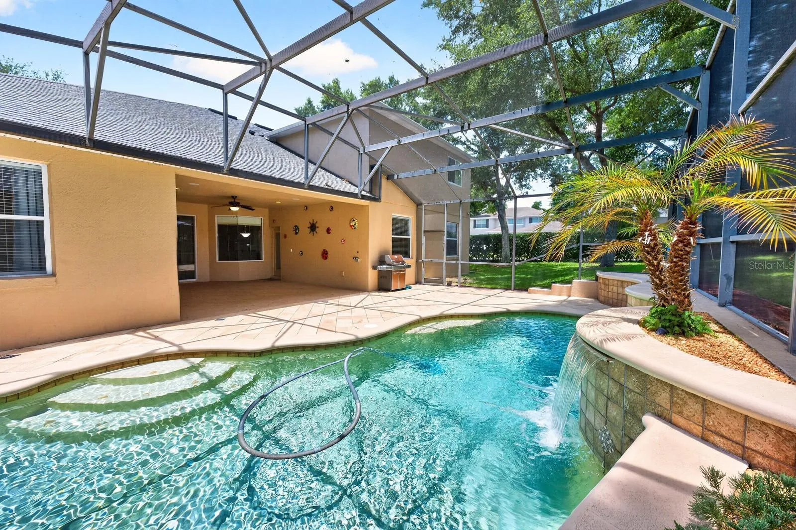 Pool is complete with a waterfall features.