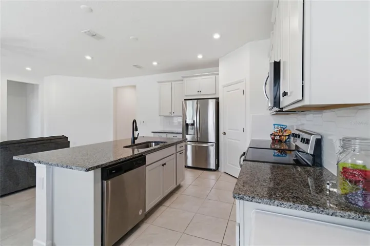 The heart of the home shines with an inviting kitchen design centered around a beautiful island and ample workspace