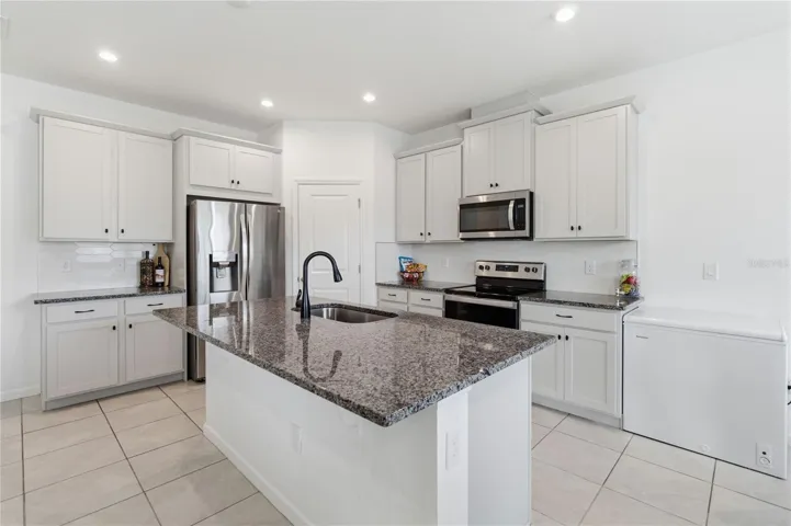 Large kitchen island offering the perfect space for meal prep, casual dining, and gathering with family and friends.