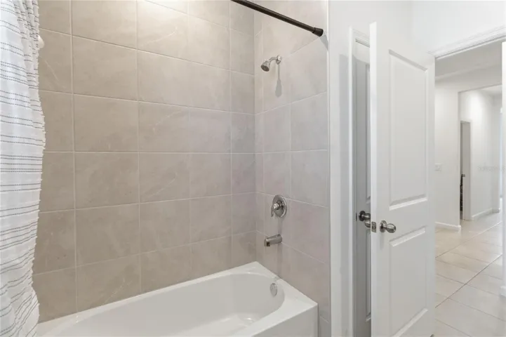 Secondary bathroom featuring a tub and shower combination designed for comfort and convenience.