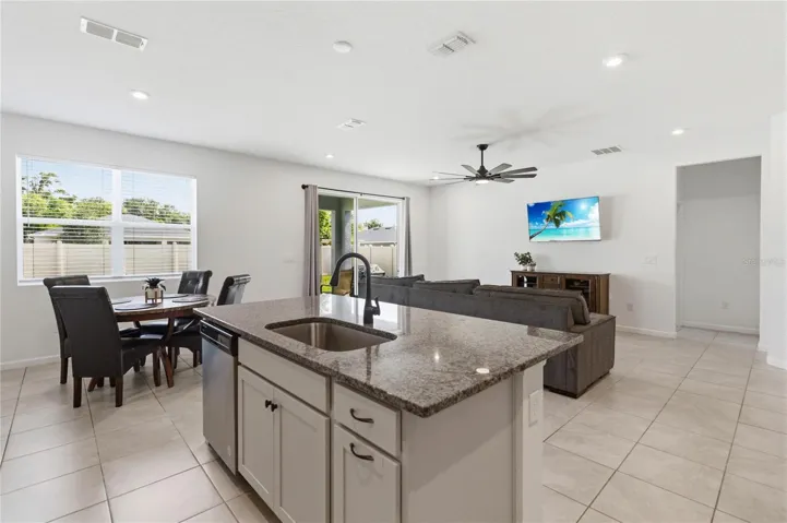 The heart of the home combines the kitchen, dinette, and family room into one inviting space with relaxing backyard views.