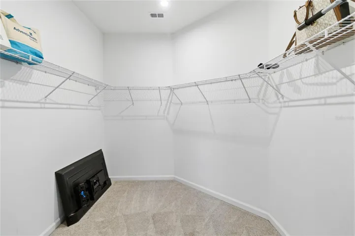 Large primary closet providing abundant room for clothing, shoes, and all your accessories.