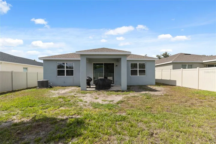 Rear exterior view showcasing the home's spacious backyard and outdoor living space.