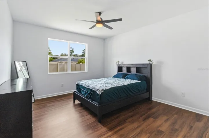 Light-filled primary bedroom with ample space for a variety of furniture layouts and design styles.