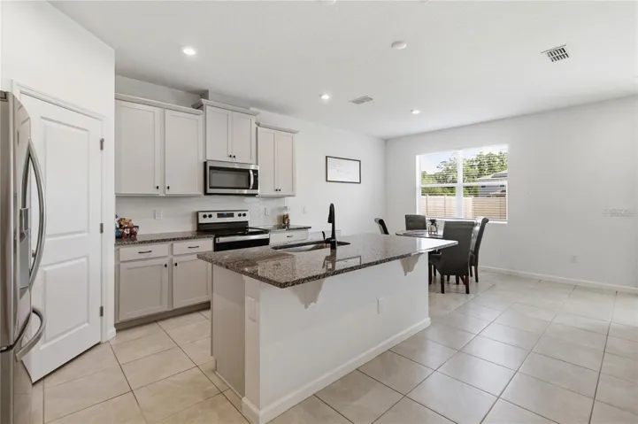 Well-designed kitchen featuring a generous island, abundant cabinetry, and an inviting layout perfect for everyday living and entertaining.