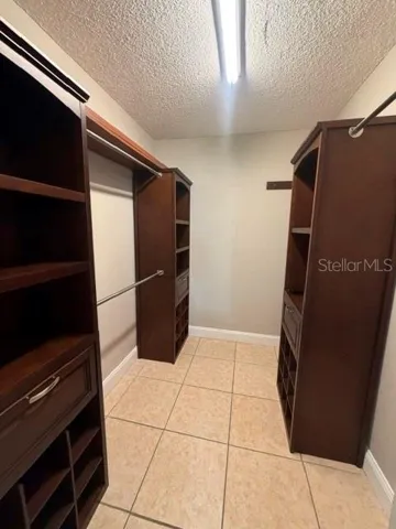 Primary closet w/ built-in cabinetry