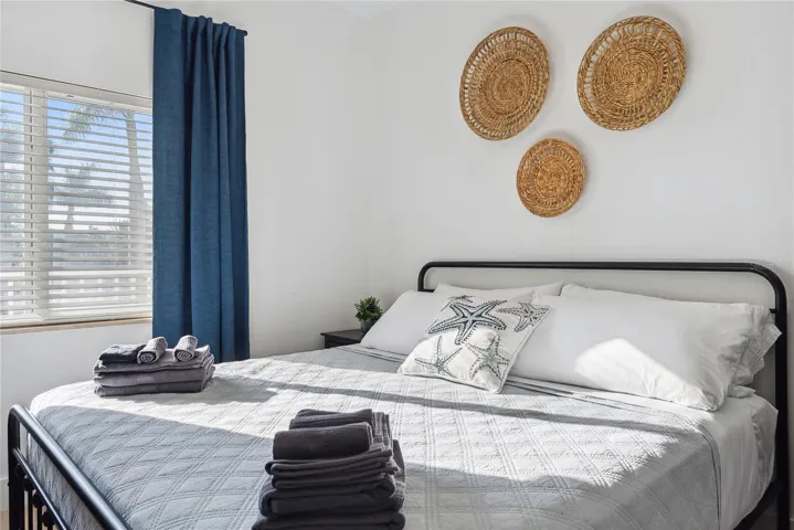 Bedroom with ceiling fan, King bed, drapes and decor included