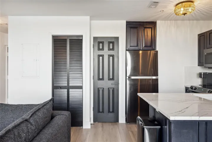 View of kitchen and closed closet doors