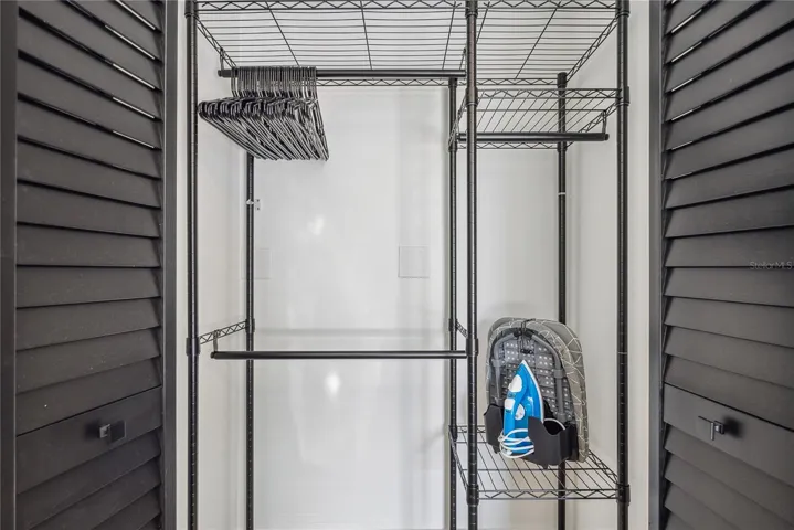 Spacious bedroom closet with storage rack