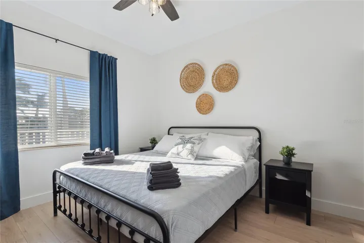 Bedroom with ceiling fan, King bed, drapes and decor included