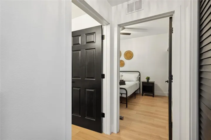 View of bedroom and bathroom door from foyer
