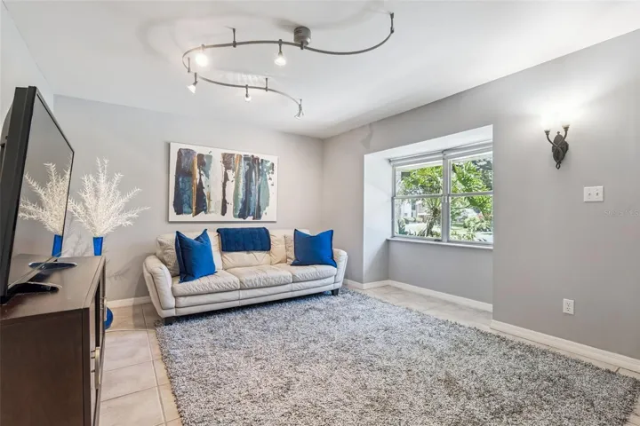 A bright, welcoming Living Room is filled with NATURAL LIGHT from the large front window.
