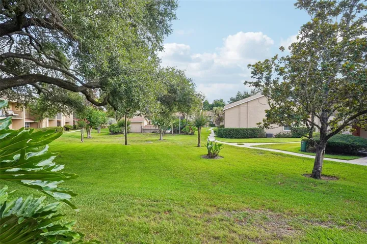 Offering the FEEL OF A TOWNHOME with two spacious levels, a private patio, and a one-car garage, this home is tucked away in a QUIET LOCATION with PEACEFUL GREEN SPACE VIEWS from the front.