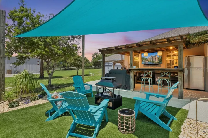 Outdoor Sitting Area towards Outdoor Kitchen at Dusk