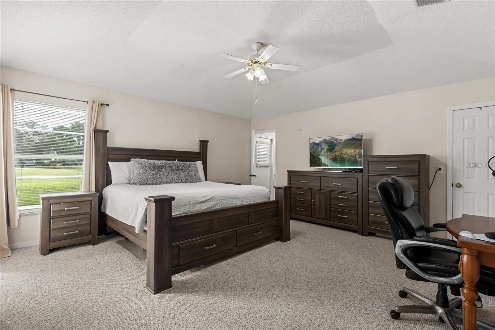 Spacious primary bedroom with plenty of natural light