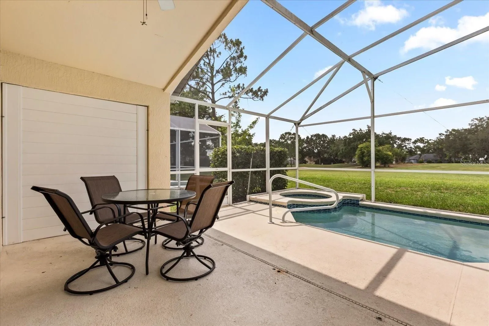 Screened pool area featuring a covered lanai, perfect for outdoor entertaining